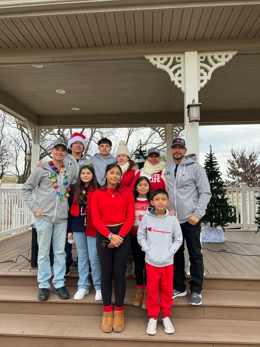 The family in Santa hats on a gazebo at the Dayton Christmas Parade