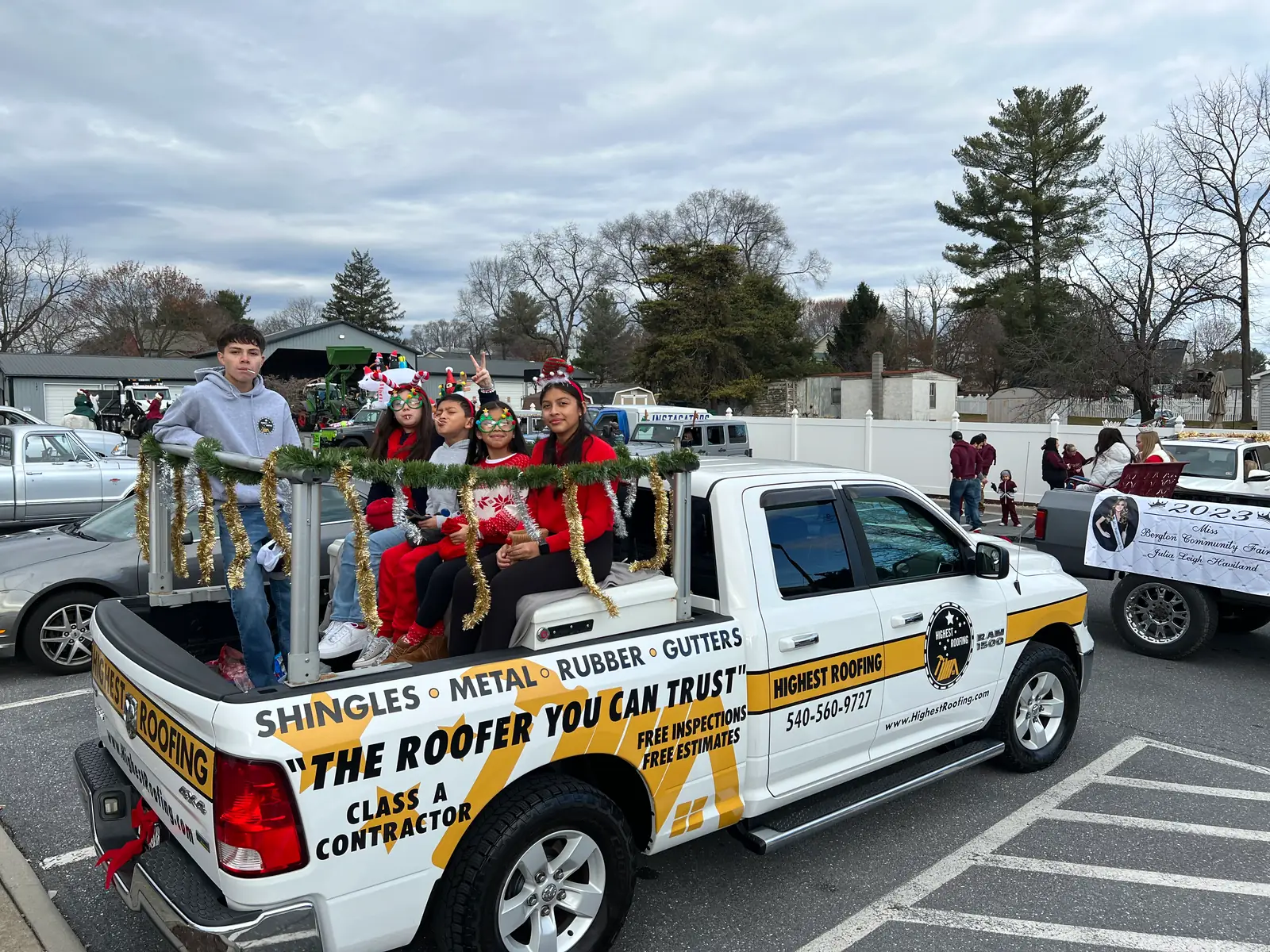 The Highest Roofing truck in the Dayton Christmas Parade, children in Santa hats in the truck bed