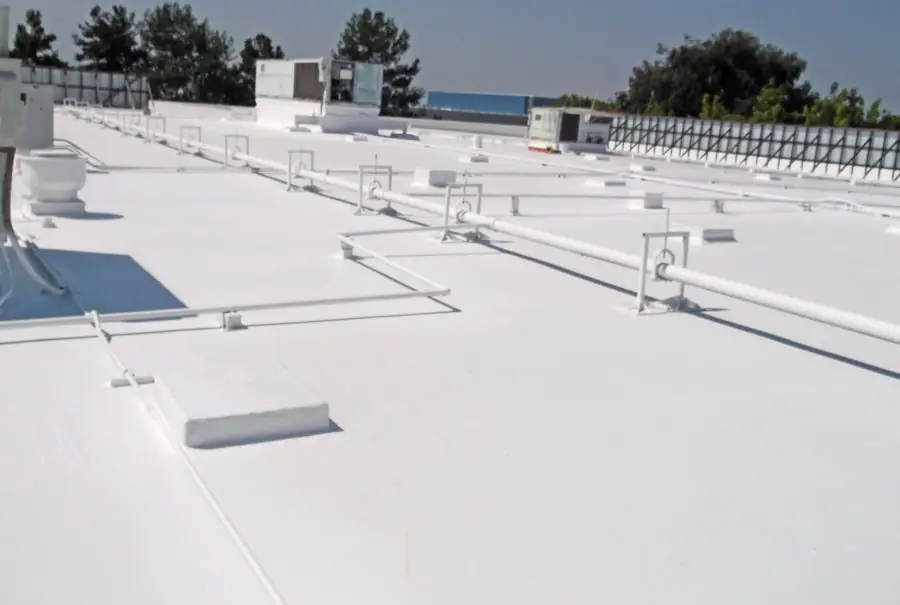 A white flat roof with a walkway and rooftop units