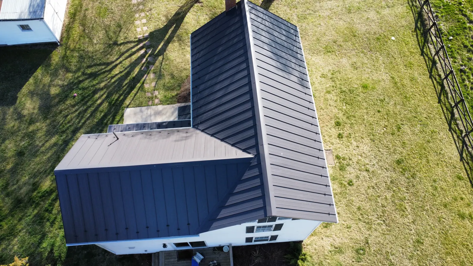 A dark standing-seam metal roof seen from straight above
